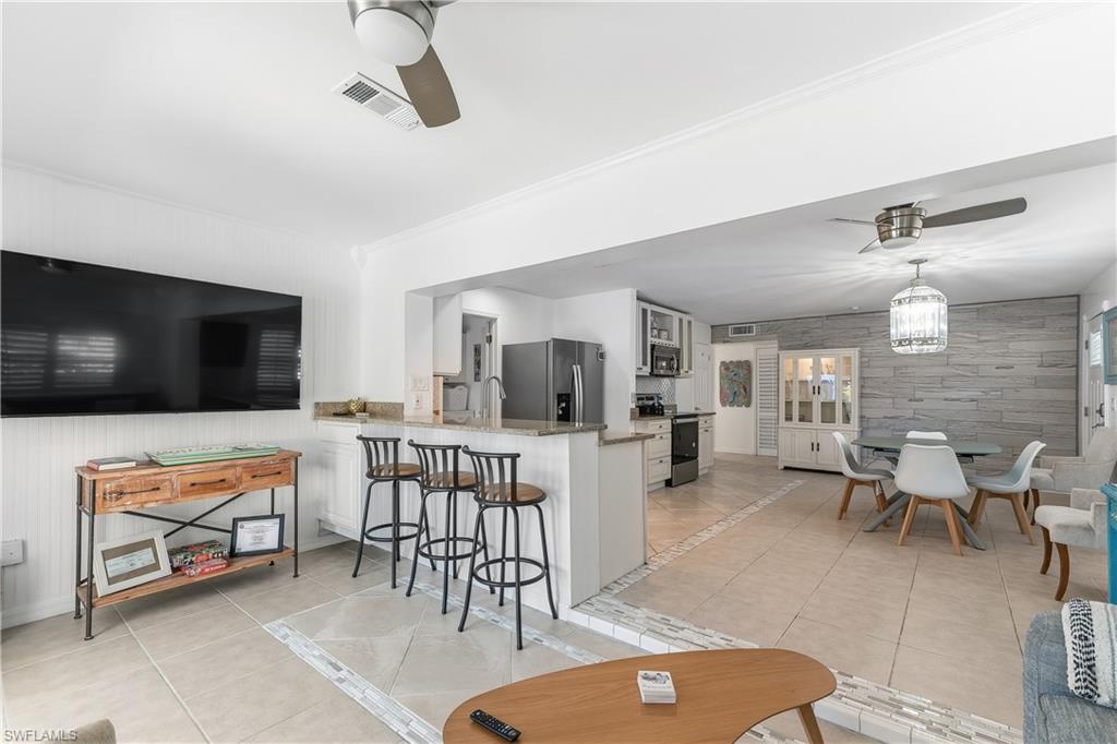 604 110th Avenue North Naples, FL 34108 - Photo 9 of 41 a living room with furniture and a flat screen tv