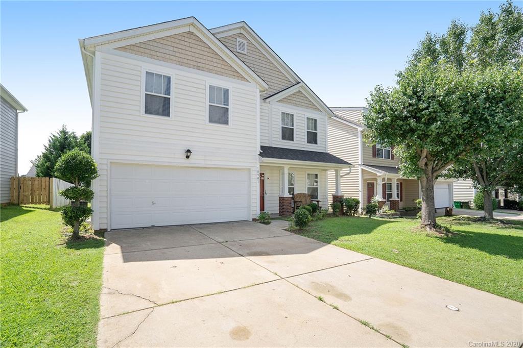10901 Slalom Hill Road Charlotte, NC 28278 - Photo 2 of 36 a view of a white house next to a yard with big trees