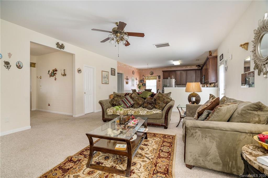 10901 Slalom Hill Road Charlotte, NC 28278 - Photo 11 of 36 a living room with furniture and a chandelier