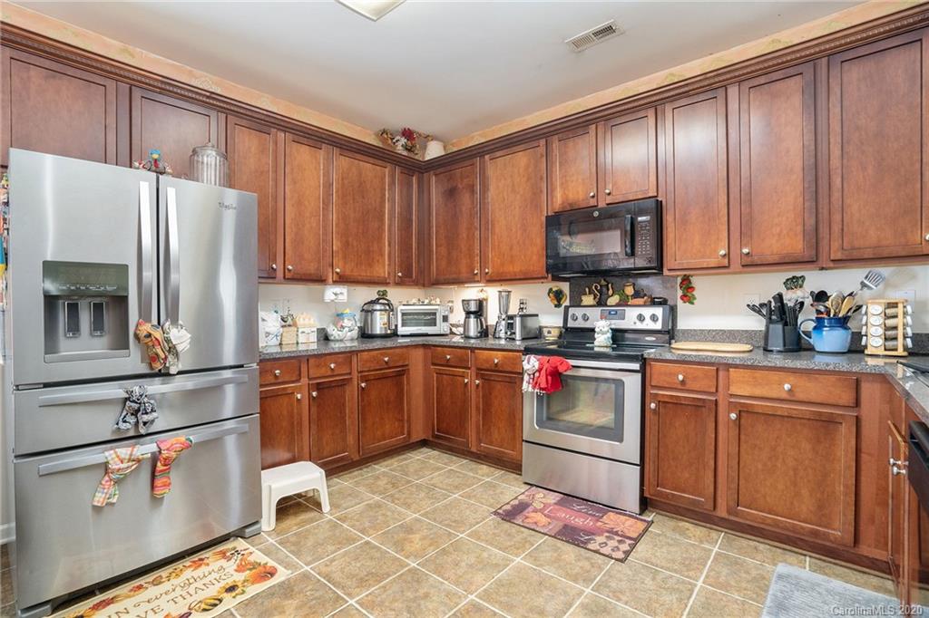 10901 Slalom Hill Road Charlotte, NC 28278 - Photo 13 of 36 a kitchen with stainless steel appliances granite countertop a refrigerator sink and cabinets