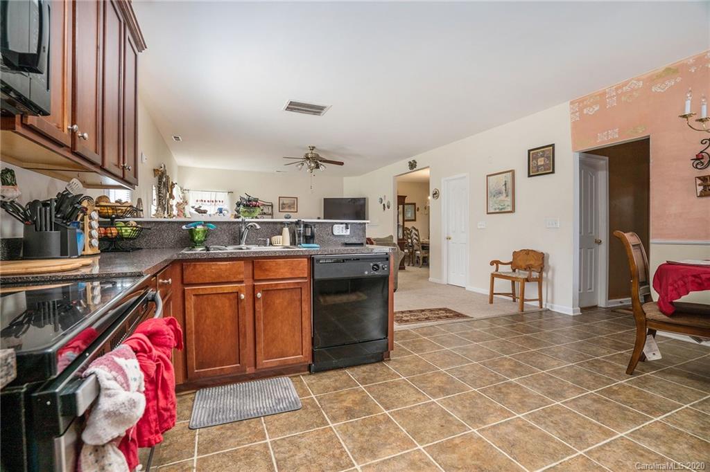 10901 Slalom Hill Road Charlotte, NC 28278 - Photo 15 of 36 a kitchen with stainless steel appliances granite countertop a sink a stove and a refrigerator