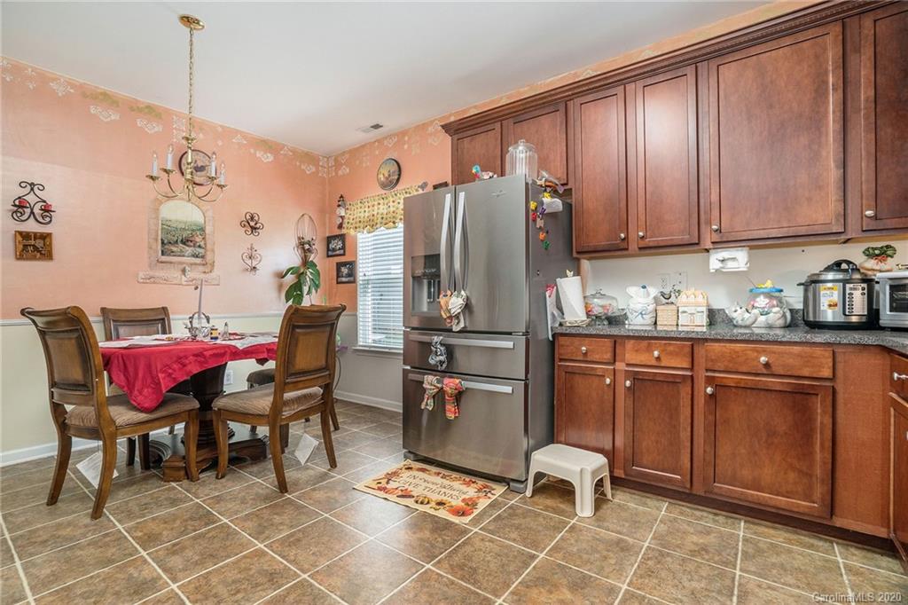 10901 Slalom Hill Road Charlotte, NC 28278 - Photo 16 of 36 a room with stainless steel appliances kitchen island granite countertop furniture a rug and a wooden floor