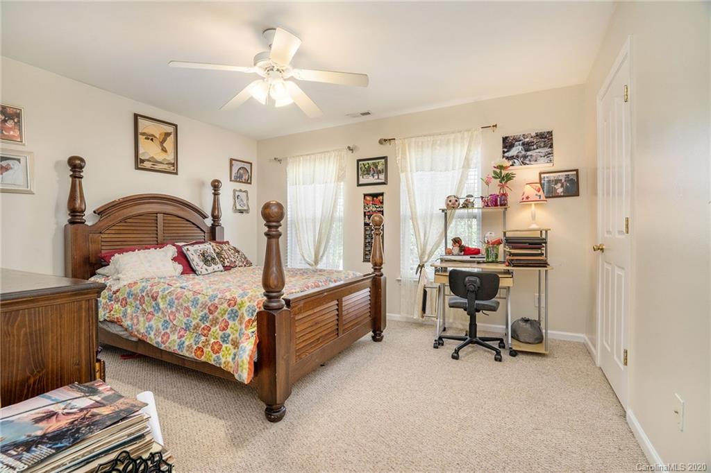 10901 Slalom Hill Road Charlotte, NC 28278 - Photo 19 of 36 a bedroom with a bed and a chandelier