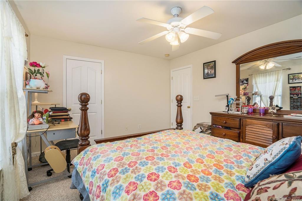 10901 Slalom Hill Road Charlotte, NC 28278 - Photo 20 of 36 a bedroom with a bed and a chandelier