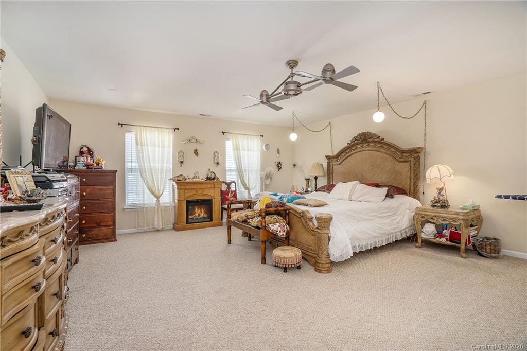 10901 Slalom Hill Road Charlotte, NC 28278 - Photo 21 of 36 a spacious bedroom with a bed and a chandelier