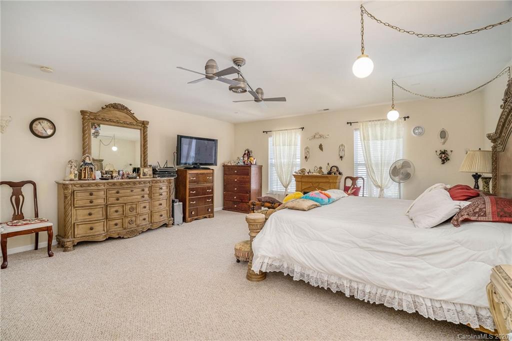 10901 Slalom Hill Road Charlotte, NC 28278 - Photo 22 of 36 a large bedroom with a bed dresser and flat screen tv