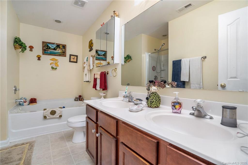 10901 Slalom Hill Road Charlotte, NC 28278 - Photo 25 of 36 a bathroom with a sink double vanity and a tub