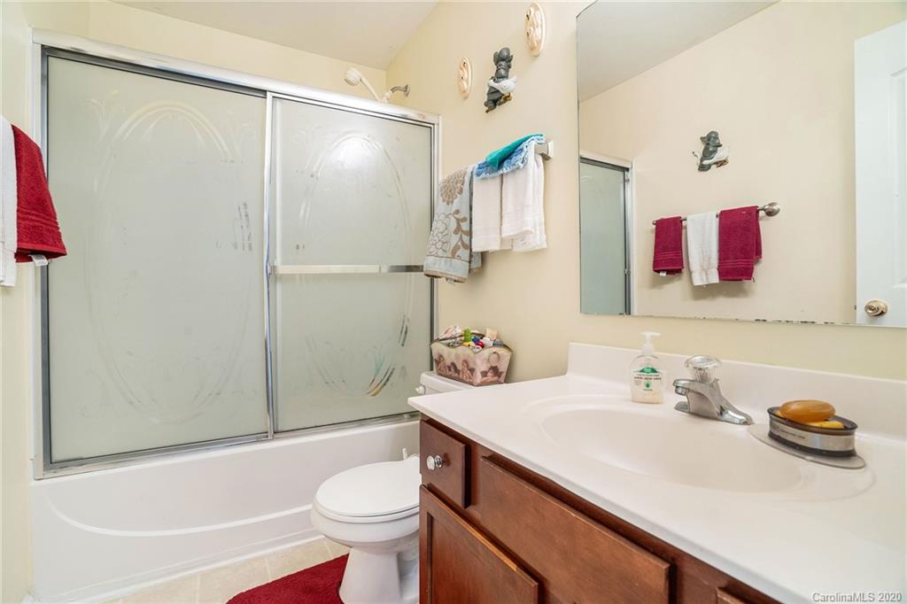 10901 Slalom Hill Road Charlotte, NC 28278 - Photo 30 of 36 a bathroom with a sink a toilet and shower