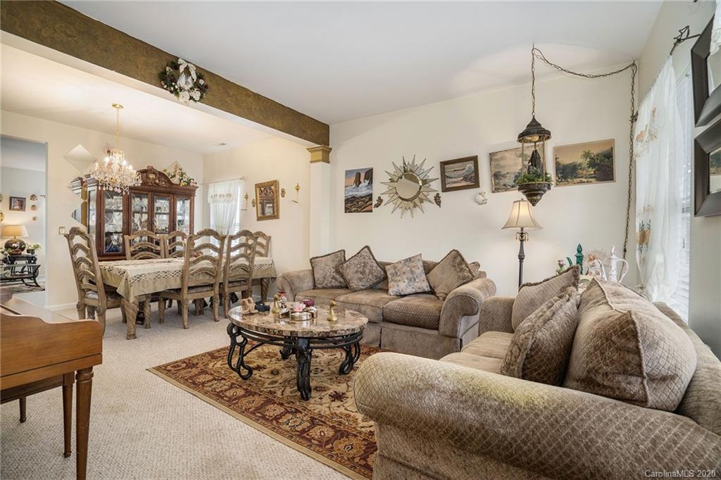 10901 Slalom Hill Road Charlotte, NC 28278 - Photo 4 of 36 a living room with furniture and a chandelier
