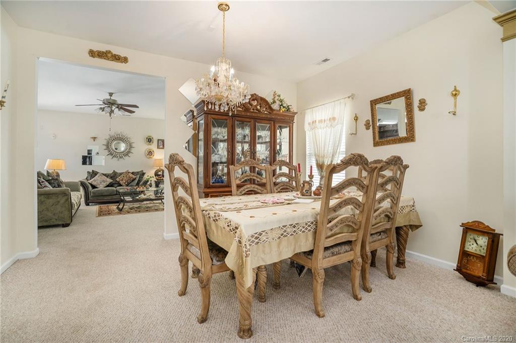 10901 Slalom Hill Road Charlotte, NC 28278 - Photo 7 of 36 a view of a dining room with furniture and chandelier