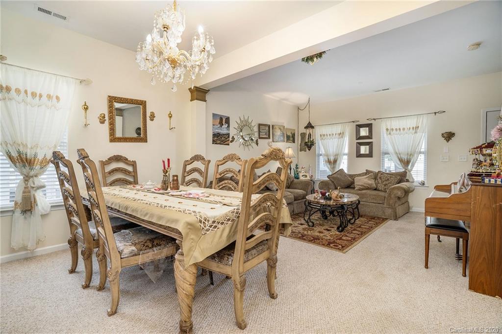 10901 Slalom Hill Road Charlotte, NC 28278 - Photo 8 of 36 a view of a dining room with furniture and chandelier