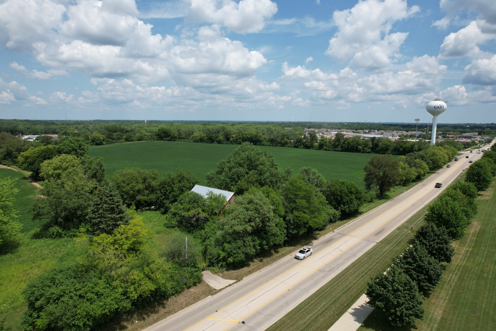 3712 Three Oaks Road Cary, IL 60013 - Photo 2 of 13 a view of a city with lush green forest