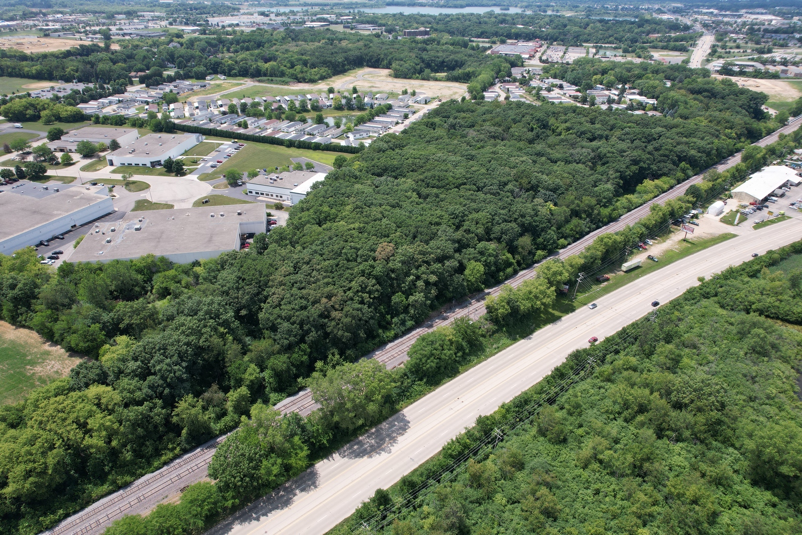 3712 Three Oaks Road Cary, IL 60013 - Photo 7 of 13 an aerial view of a city with lots of residential buildings and mountain view in back