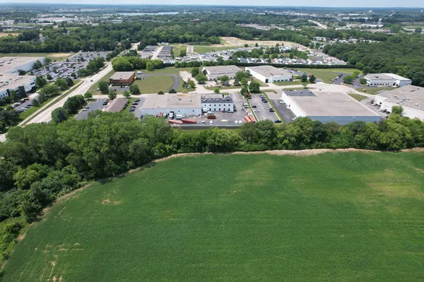 an aerial view of residential houses with outdoor space and river view