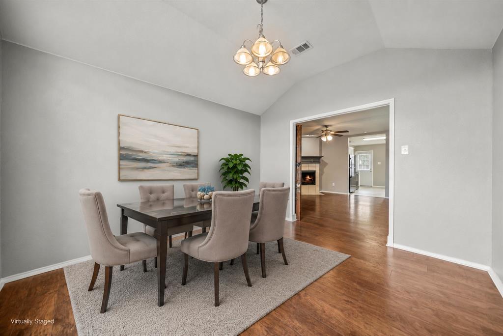 834 Hazel's Way Anna, TX 75409 - Photo 8 of 21 Dining area featuring vaulted ceilings, wood-finish flooring, and a decorative chandelier