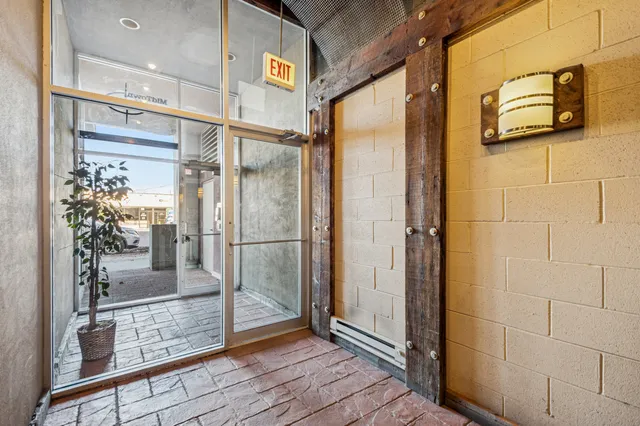 a bathroom with a glass door shower and mirror