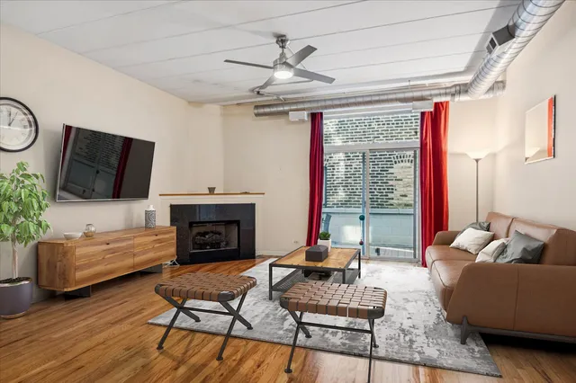 a living room with furniture fireplace and flat screen tv