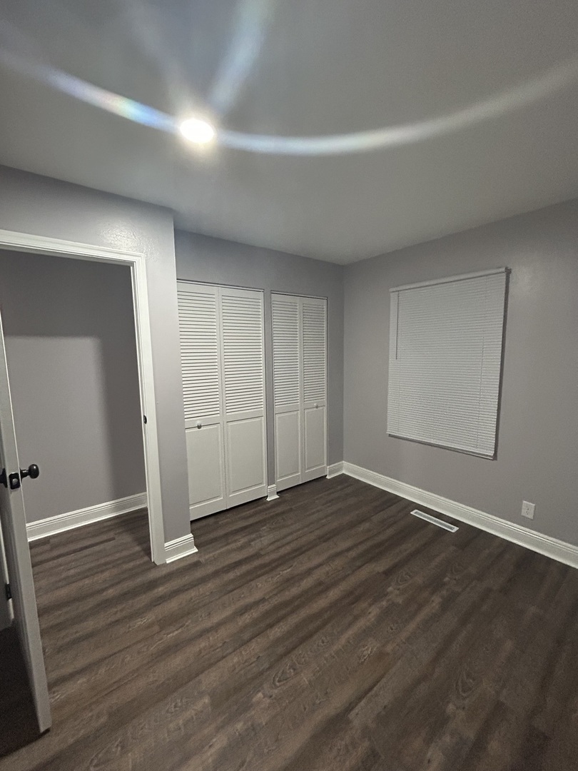 616 Parkside Circle Streamwood, IL 60107 - Photo 12 of 15 a view of an empty room with wooden floor