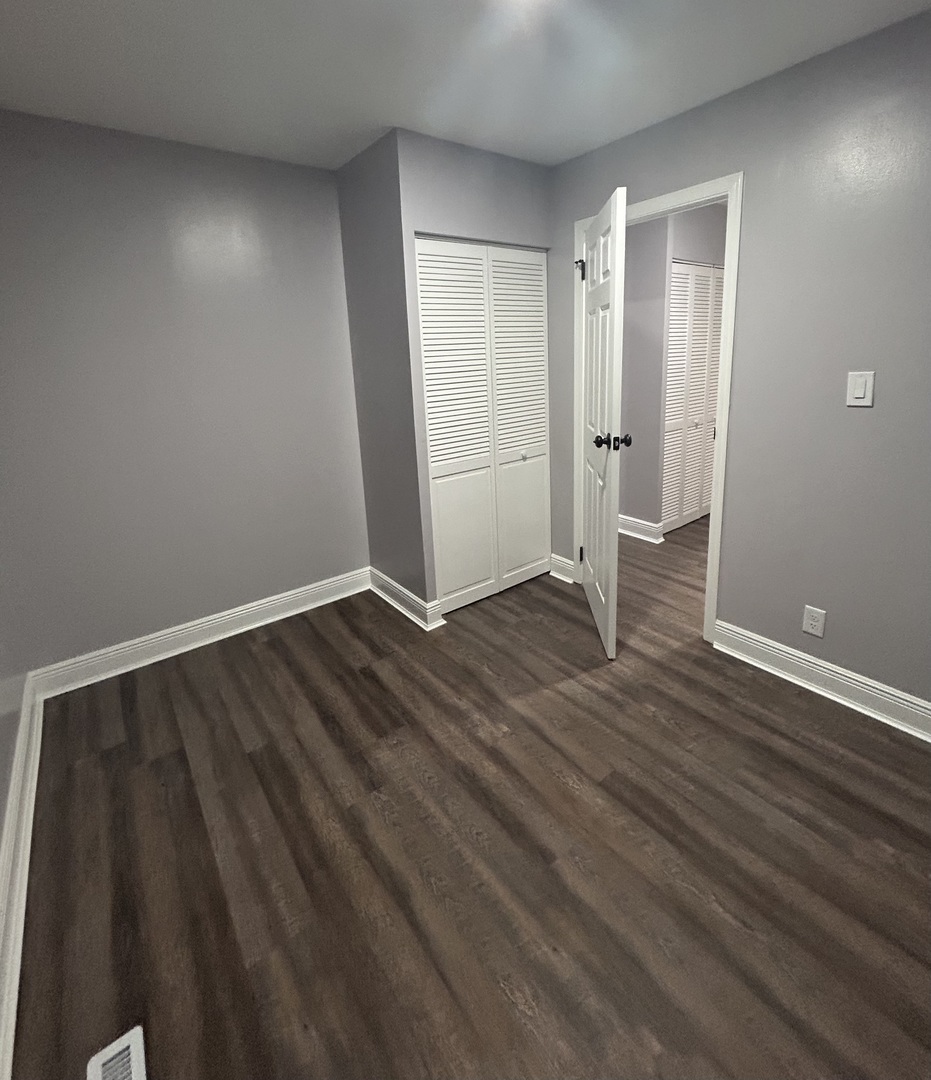 616 Parkside Circle Streamwood, IL 60107 - Photo 13 of 15 a view of an empty room with wooden floor and a window