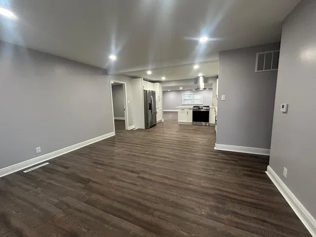 a view of a hallway with wooden floor