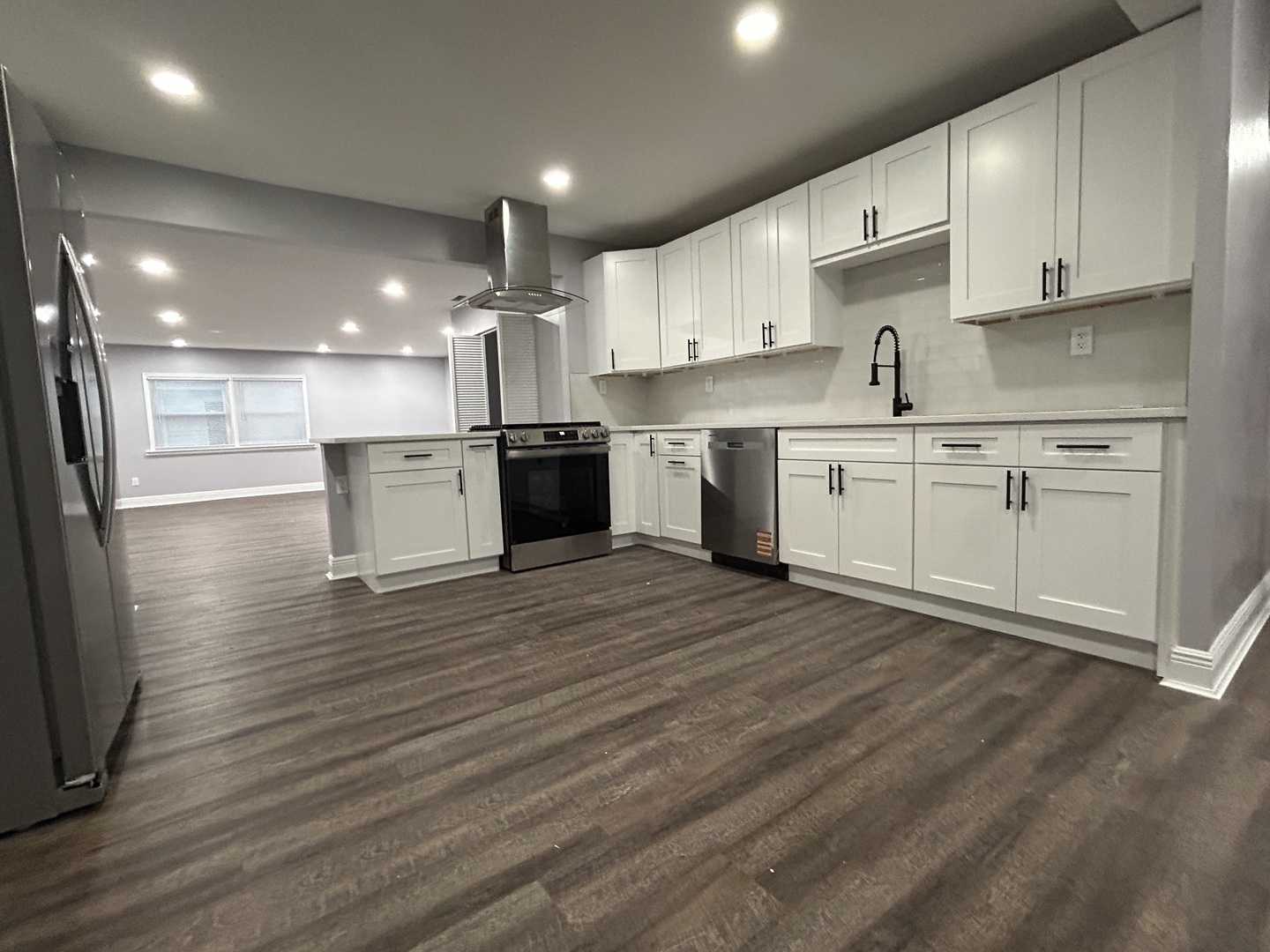 616 Parkside Circle Streamwood, IL 60107 - Photo 6 of 15 a large kitchen with granite countertop a large counter top a sink stainless steel appliances and cabinets