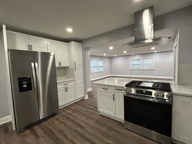 a kitchen with a stove and a refrigerator