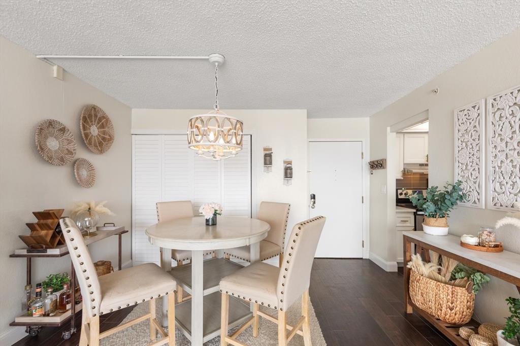 255 Dolphin Point, Unit 508 Clearwater Beach, FL 33767 - Photo 11 of 40 a view of a dining room with furniture and wooden floor