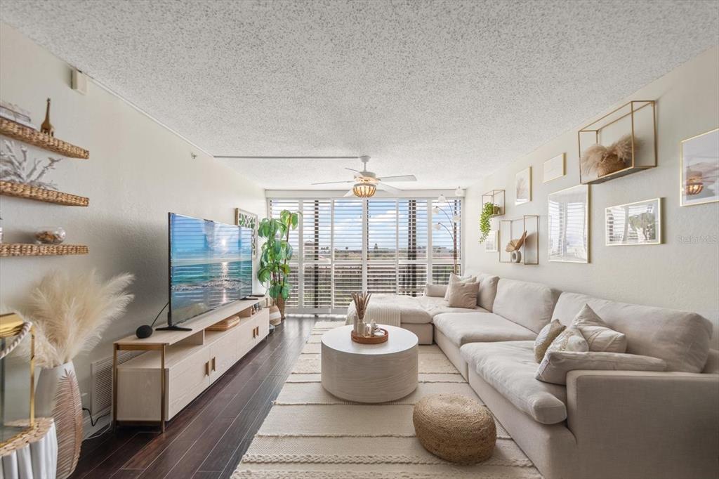 255 Dolphin Point, Unit 508 Clearwater Beach, FL 33767 - Photo 13 of 40 a living room with furniture and a potted plant
