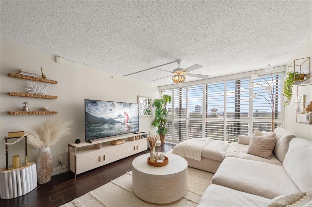 255 Dolphin Point, Unit 508 Clearwater Beach, FL 33767 - Photo 14 of 40 a living room with furniture and a flat screen tv