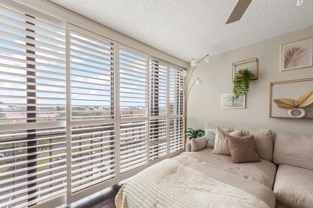 255 Dolphin Point, Unit 508 Clearwater Beach, FL 33767 - Photo 16 of 40 a bedroom with a large bed and a large window