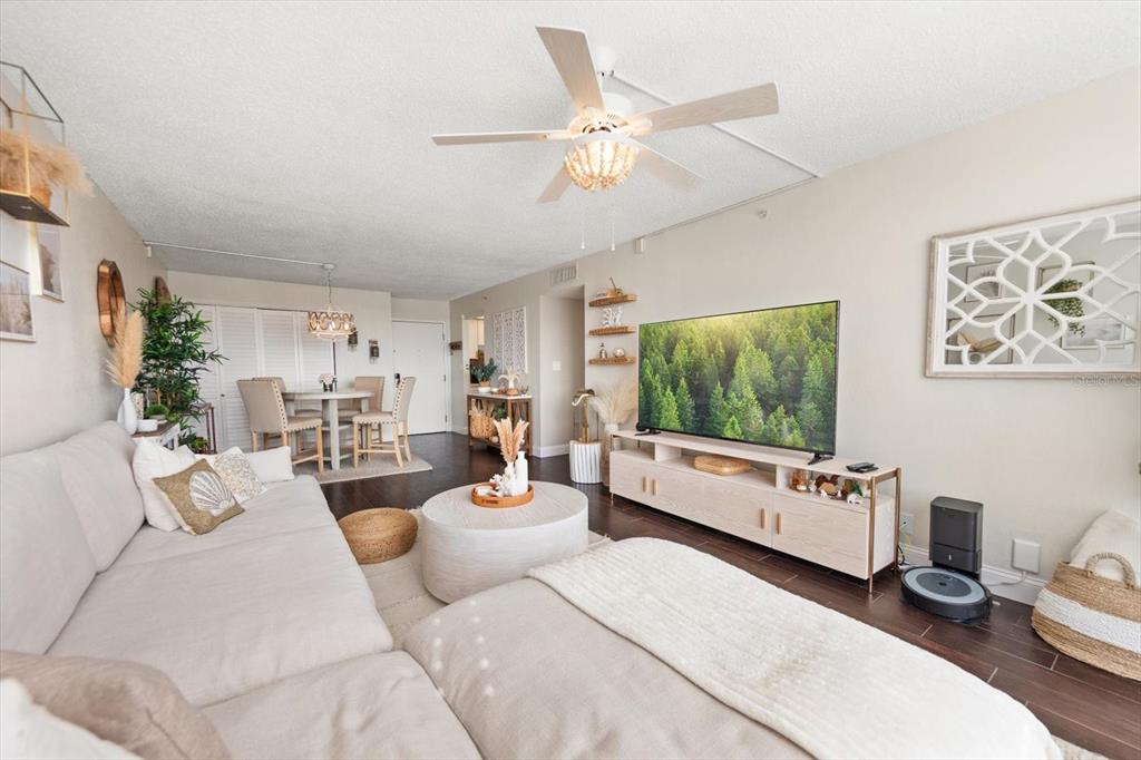255 Dolphin Point, Unit 508 Clearwater Beach, FL 33767 - Photo 18 of 40 a living room with furniture and a flat screen tv