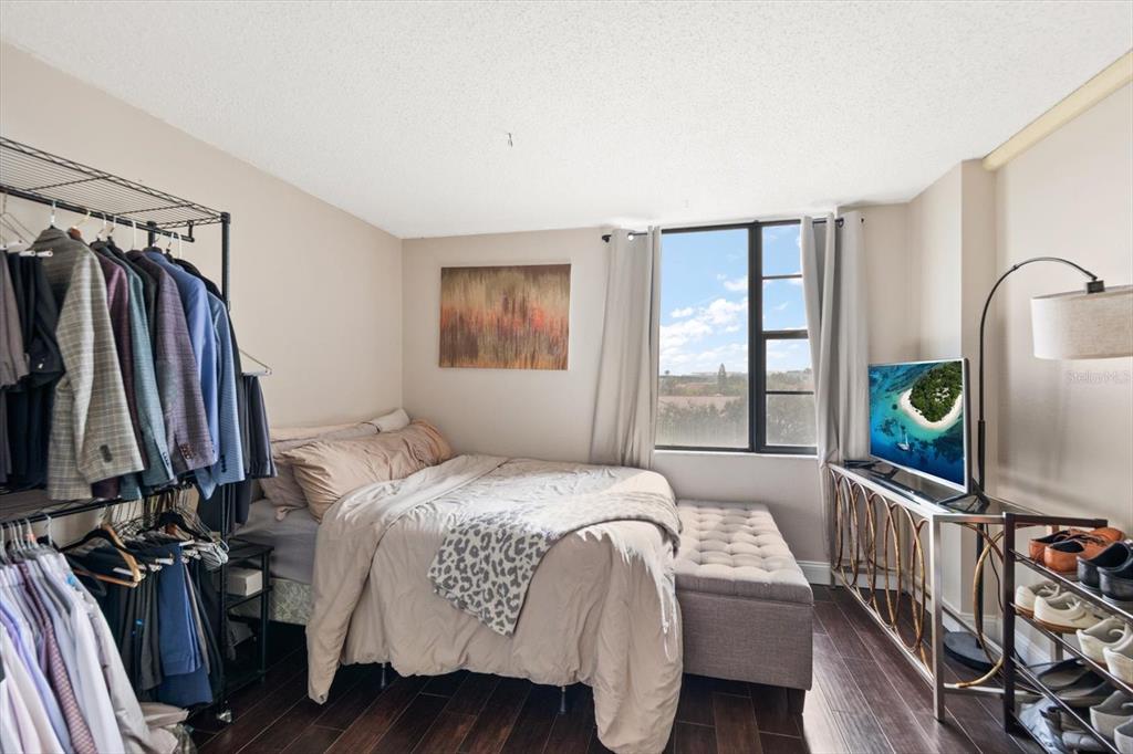 255 Dolphin Point, Unit 508 Clearwater Beach, FL 33767 - Photo 23 of 40 a bedroom with a bed a flat screen tv and a window