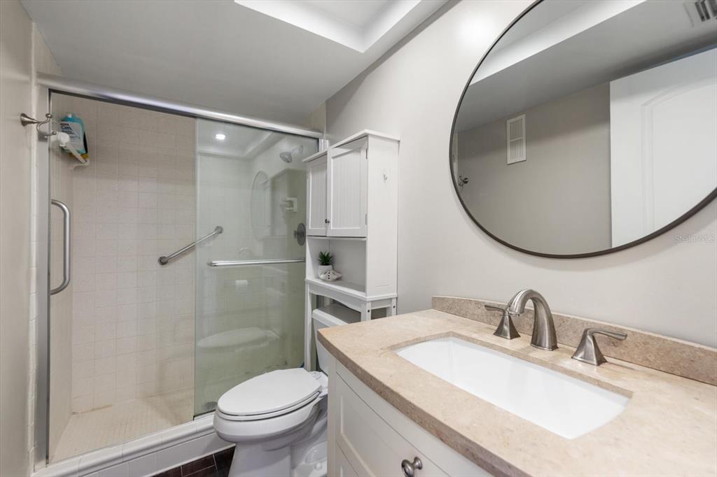 255 Dolphin Point, Unit 508 Clearwater Beach, FL 33767 - Photo 25 of 40 a bathroom with a sink toilet and a mirror