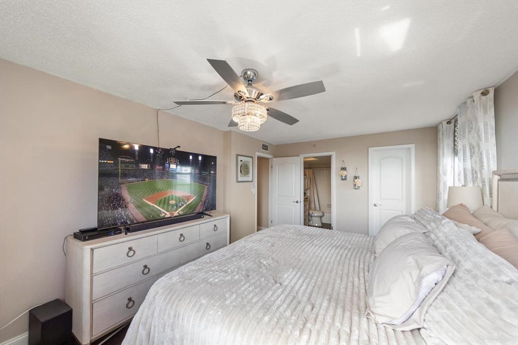 255 Dolphin Point, Unit 508 Clearwater Beach, FL 33767 - Photo 29 of 40 a bedroom with a bed and a flat screen tv