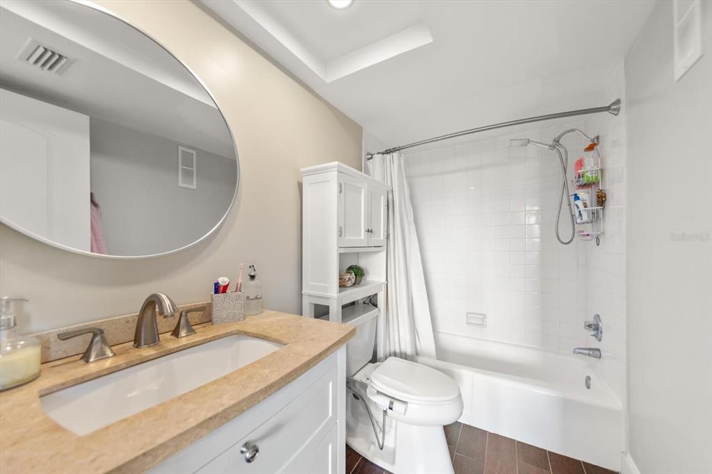 255 Dolphin Point, Unit 508 Clearwater Beach, FL 33767 - Photo 30 of 40 a bathroom with a sink a toilet and a mirror