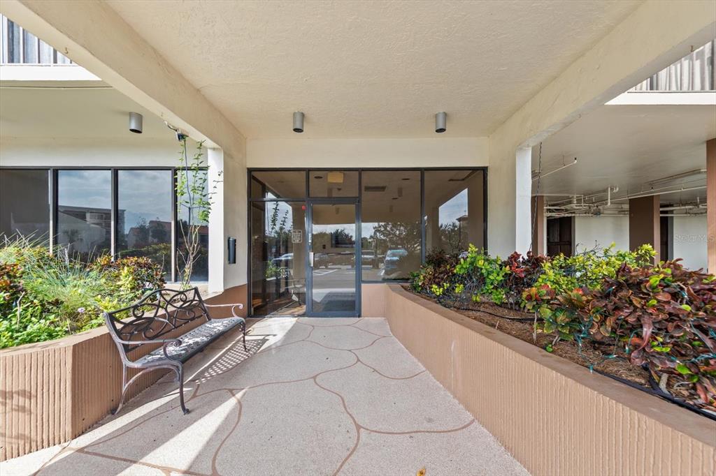 255 Dolphin Point, Unit 508 Clearwater Beach, FL 33767 - Photo 3 of 40 a lobby with flowers and flowers