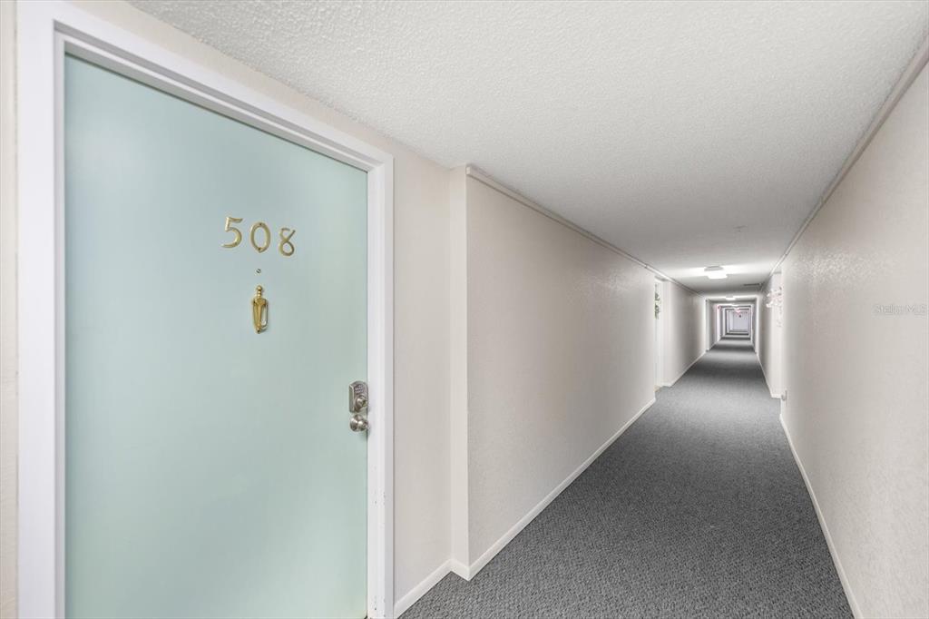 255 Dolphin Point, Unit 508 Clearwater Beach, FL 33767 - Photo 9 of 40 a view of hallway with livingroom