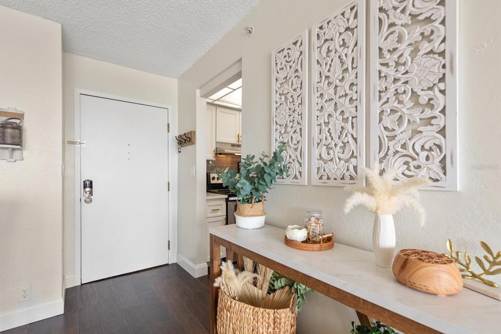 255 Dolphin Point, Unit 508 Clearwater Beach, FL 33767 - Photo 10 of 40 a table and a vase with flowers on it