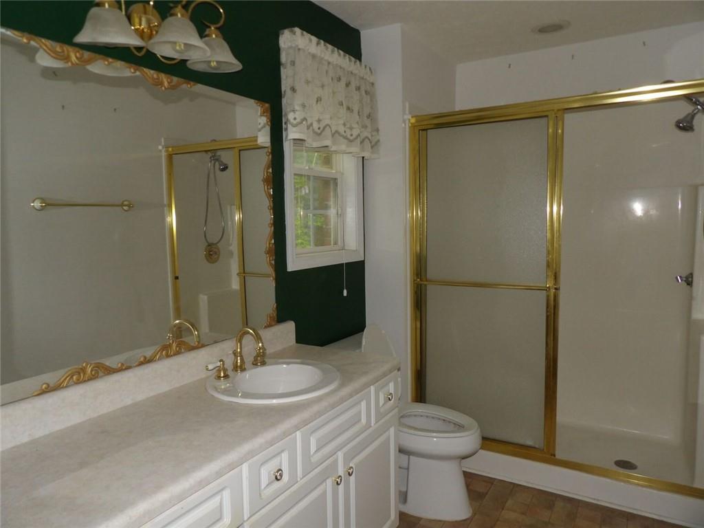 676 Graham Road Dallas, GA 30132 - Photo 11 of 19 a bathroom with a sink toilet and shower