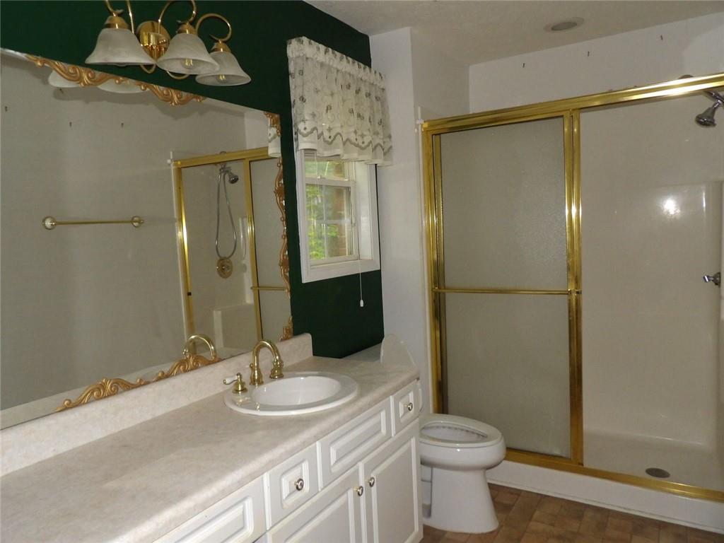 676 Graham Road Dallas, GA 30132 - Photo 12 of 19 a bathroom with a sink toilet and shower