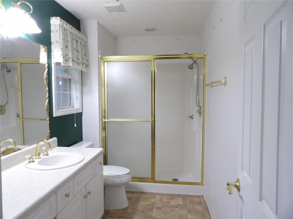 676 Graham Road Dallas, GA 30132 - Photo 13 of 19 a bathroom with a sink toilet and shower