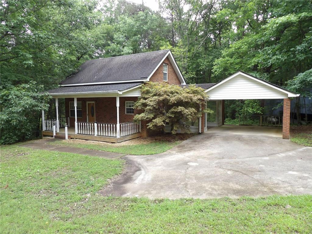676 Graham Road Dallas, GA 30132 - Photo 2 of 19 a house with trees in the background
