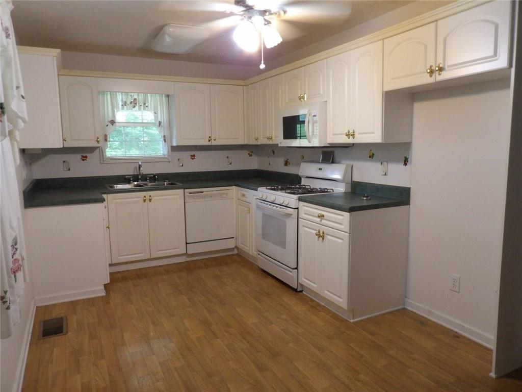 676 Graham Road Dallas, GA 30132 - Photo 4 of 19 a kitchen with a sink cabinets and window