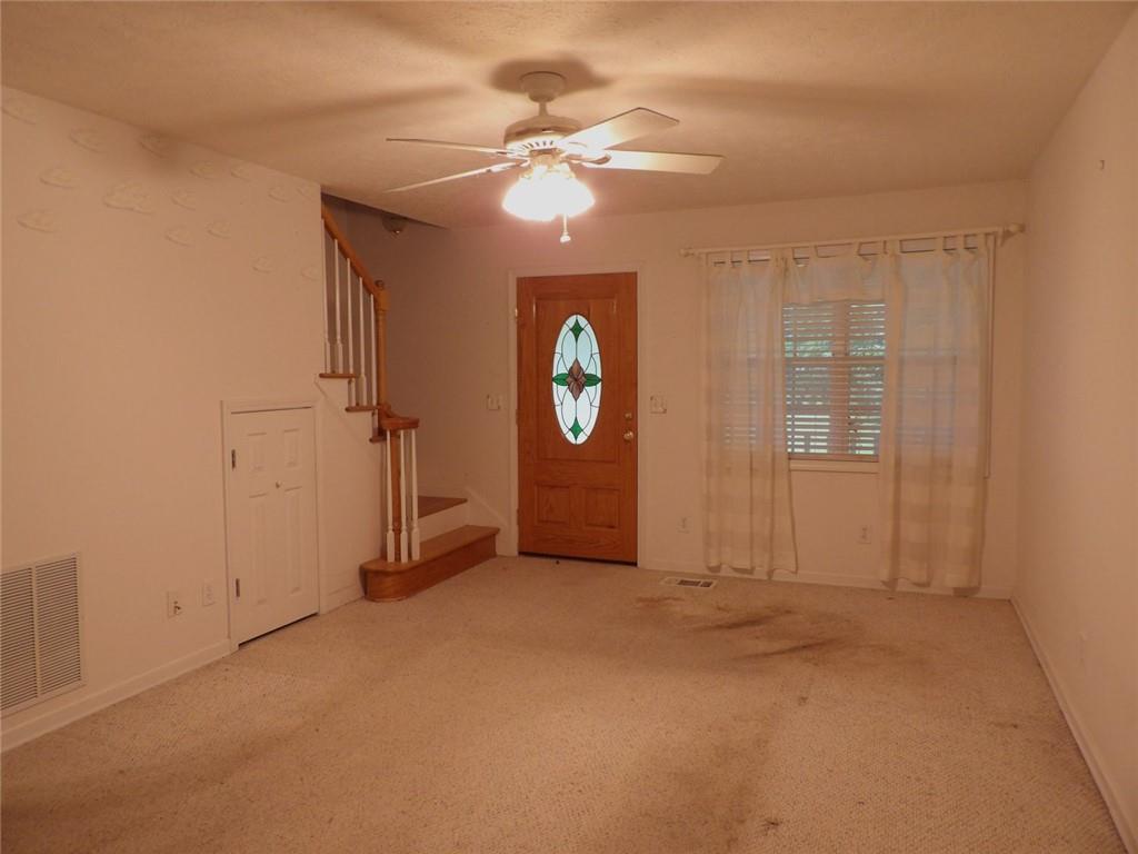 676 Graham Road Dallas, GA 30132 - Photo 7 of 19 a view of a hallway with a chandelier fan and windows