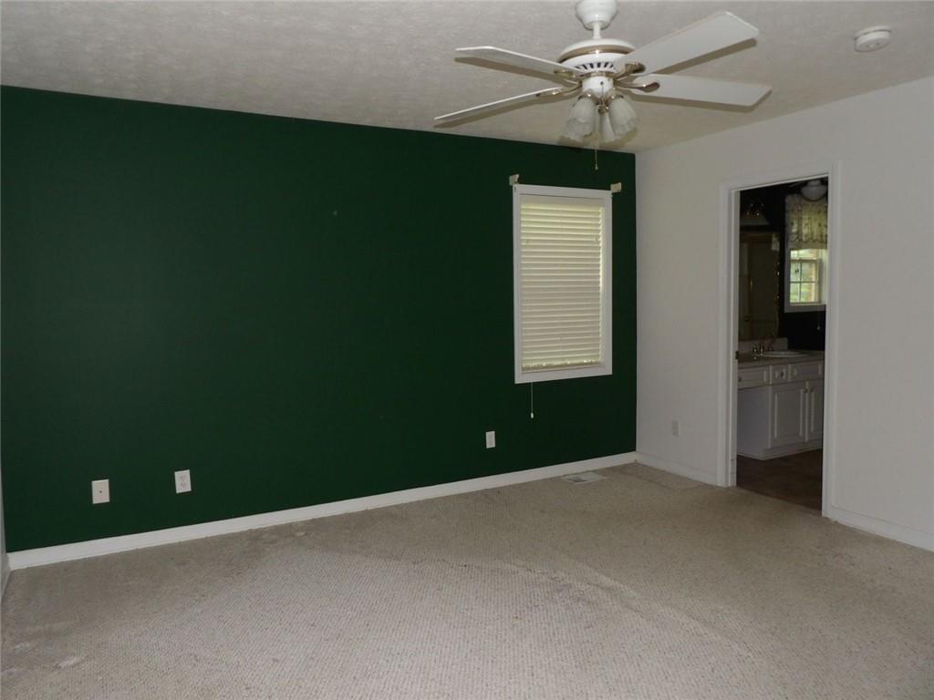 676 Graham Road Dallas, GA 30132 - Photo 9 of 19 an empty room with windows and fan