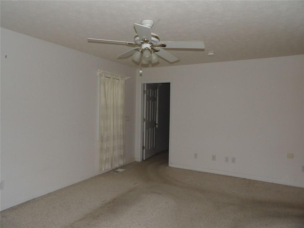 676 Graham Road Dallas, GA 30132 - Photo 10 of 19 an empty room with a chandelier fan and closet