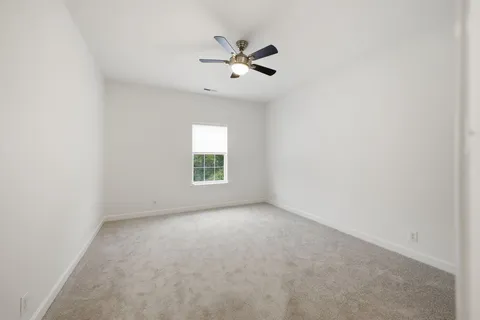 a view of a room with an empty space and a window