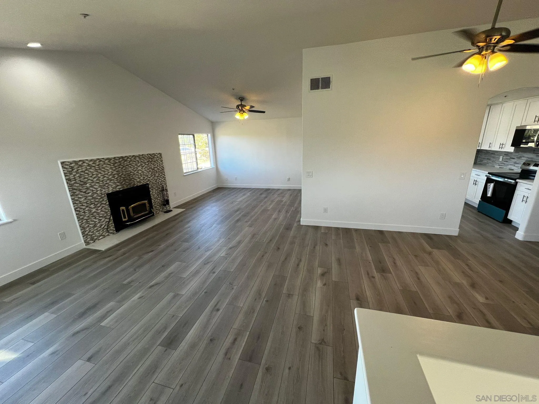 29938 Canadian Honker Road Campo, CA 91906 - Photo 3 of 20 a view of a livingroom with wooden floor and a fireplace