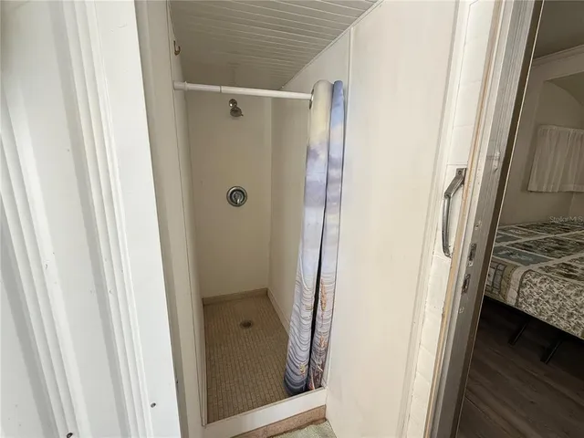 a bathroom with a glass door shower and a sink