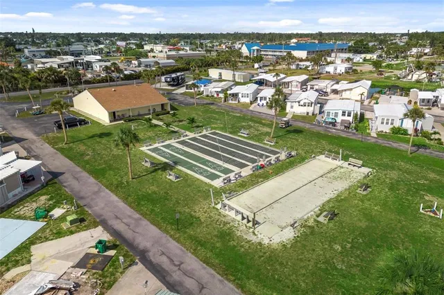 an aerial view of residential houses with outdoor space and swimming pool